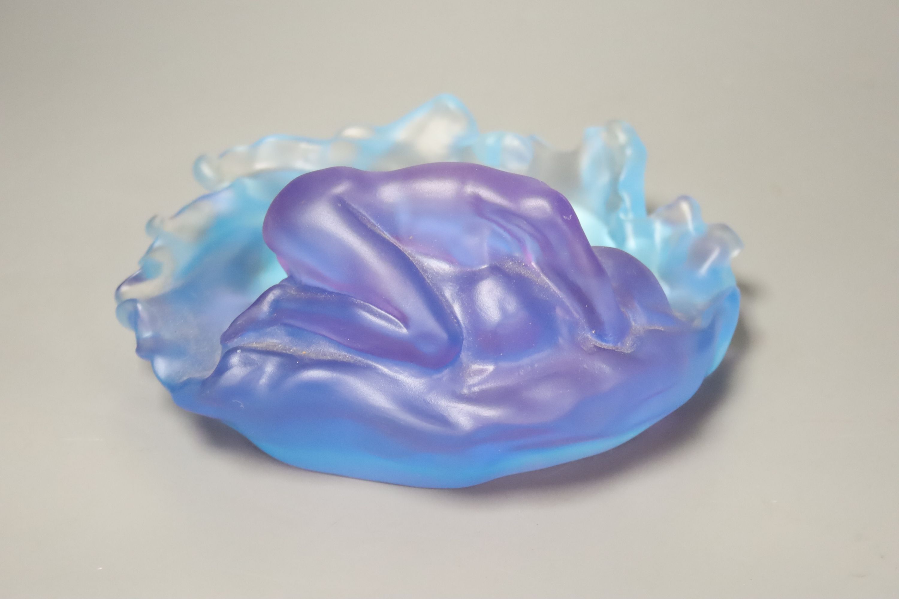 A blue and lilac glass dish with a kneeling nude, apocryphal Daum mark 18cm long